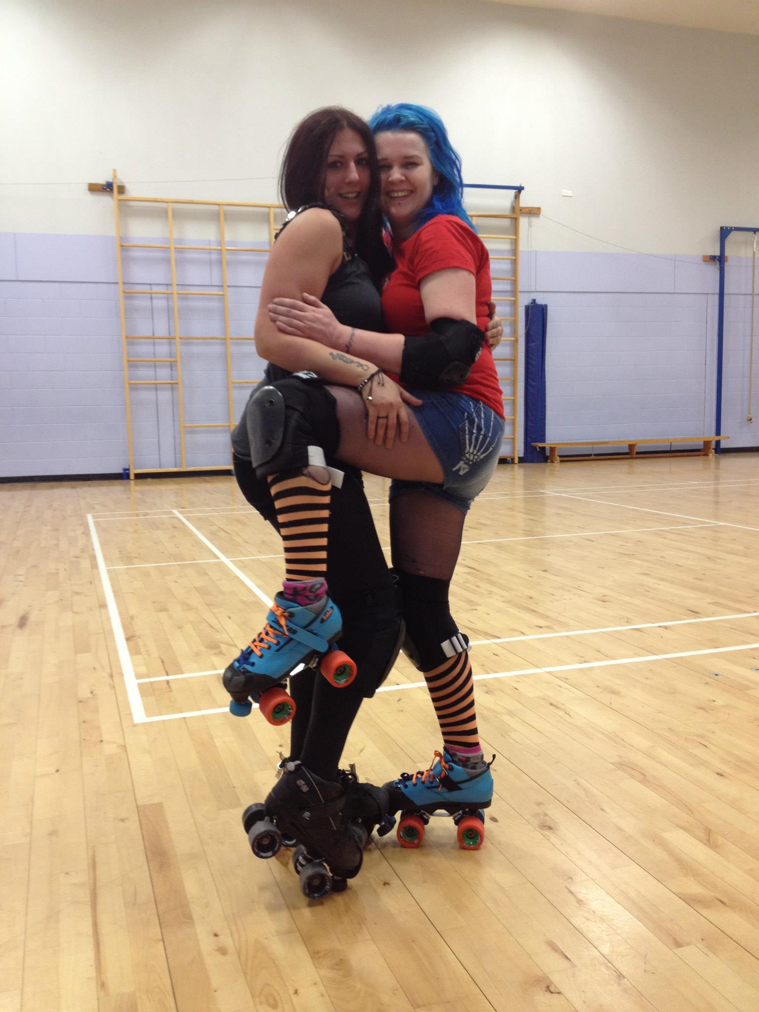 Irn Bruzer (now with appropriately blue hair!) poses with derby-wife Natorious Red at their Christmas skate.
